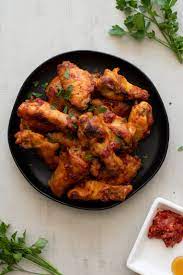 Honey Harissa Chicken Wings With Two Spoons