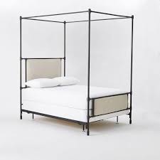 Edged with iron corners finished in glam plated brass, dark design rises 80 high from the ground. Rhodes Upholstered Black Metal Canopy Bed