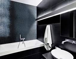 A clean, minimalist looking bathroom design uses a contemporary shaped tub and reflective glass to bring the whole space. Mosaic Tiles For Interior Design