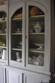 The Wire Inside Gives This Cabinet Such A Different Look Grey Cabinets Cottage Exterior Chicken Wire