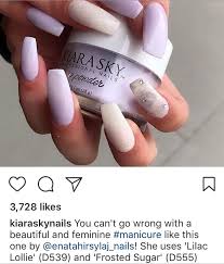 The other nails are accented with white and black floral designs, which is pleasing to the eye. Kiara Sky Dip Powder Swatches Pastel Purple And Glitter White Lilac Lollie D539 And Frosted Sugar D555 Sns Nails Colors Dip Nail Colors Lilac Nails