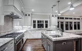Full height stone slabs and white porcelain farmhouse sink on the island became a finishing touch for this remarkable modern kitchen. How To Choose The Right Countertop For Your Kitchen Kukun White Granite Kitchen White Granite Countertops White Modern Kitchen