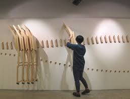 Collapsible Chairs Hang On Wall In Undulating Line When They Are Not In Use Efficient Use Of Space Design Element Folding Chair Chair Wooden Folding Chairs