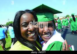 Sgt. 1st Class Mericia Land, Headquarters and Headquarters Company, 244th  Quartermaster Battalion, and her daughter Jessica Thomas embrace following  the Prince George High School graduation June 16 at the school's athletic  stadium