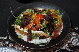 Slice the goats' cheese in half to make two discs and coat in the crushed peppercorns. A Most Unusual Bruschetta Goat Cheese Mousse On Toast With Tomato Salad And Crispy Pastrami Remcooks