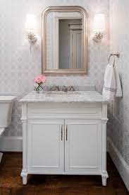 White And Gray Powder Room Features Walls Clad In Gray Geometric Wallpaper Lined With A White Sing Powder Room Vanity Powder Room Small Gray Wallpaper Bathroom