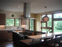 Clear glass globe pendants hang over a kitchen island boasting a white quartz countertop fitted with a prep sink and a polished nickel gooseneck faucet. 45 Bay Window Ideas With Modern Interior Design Matchness Com