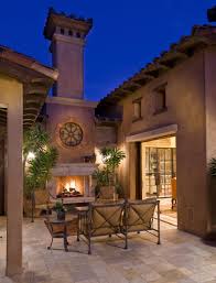 A mediterranean style outdoor patio with a fireplace features canterra stone in the color is tobacco. Tuscan Style Patio Decorating Houzz