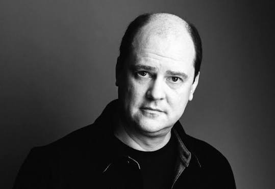 Image shows Horror filmmaker Mike Flanagan looking at the camera. 