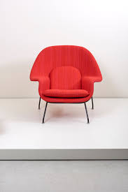 A stainless steel frame and fire retardant foam cushions upholstered with aniline leather. Womb Chair With Ottoman By Eero Saarinen For Knoll