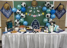 Cow And Farm Themed Blue Green Baby Shower With A Cow Tractor Diaper Cake Farm Baby Shower Cow Baby Showers Cowboy Baby Shower