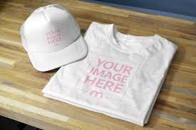 Time for the free templates! Folded T Shirt And Cap Hat On Wood Table Mediamodifier