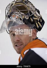 Philadelphia Flyers goalie Antero Niittymaki, of Finland, is congratulated  by teammates Jon Sim (11), Kim Johnsson, of Sweden, and Derian Hatcher (2)  after beating the Calgary Flames, 1-0, in a shootout following