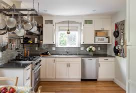 L shaped kitchen with creamy shaker kitchen cabinets paired with gray quartz countertops and beveled marble subway tile. How To Make The Most Of Your L Shaped Kitchen