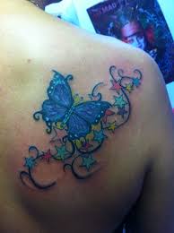 Most girls used to have these kinds of tattoo designs. I Want A Butterfly With Stars Representing The Loved Ones I Ve Lost Butterfly Name Tattoo Butterfly Tattoos For Women Star Tattoos