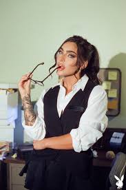 Emjay Rinaudo presents her busty figure stripping the office attire