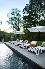 Black And White Striped Pool Umbrella What An Amazing Poolside Hangout With Black And White Stripes White Umbrellas Slate Pavers And Plenty Outdoor Pool Furniture Pool Lounge Chairs Pool Houses