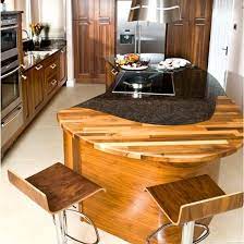 Don't feel compelled to match all countertop surfaces in the kitchen; Granite Mixed With Butcher Block Curved Kitchen Curved Kitchen Island Kitchen Island Design