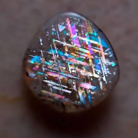 At first glance, this looks like a piece of futuristic technology trapped  inside crystal—but it's actually a real gemstone called Rainbow Lattice  Sunstone. Found only in a small, remote area of Australia's
