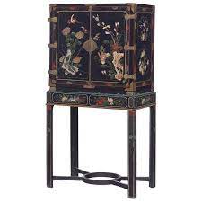 There are two main large chinese cabinets: An 18th Century Black Lacquered Brass And Chinese Coromandel Cabinet On Stand For Sale At 1stdibs