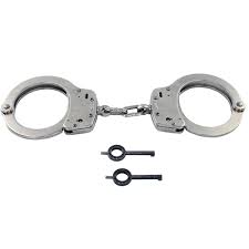 The magician is handcuffed as his assistants construct a box between two ramps. Quality Police Handcuffs For Sale Free Handcuff Engraving
