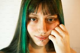 A woman with green hair is posing for a picture photo