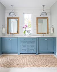 Check out these gorgeous blue cabinets and brass fixtures. White And Blue Lake House Master Bathroom Lake House Bathroom Lake House Interior House Bathroom