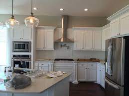 The pot filler should be placed to the right or left of the cooking surface to avoid reaching over the cooking surface to access. Builder Installed Pot Filler Way Too High What Should I Do