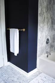 Such a gorgeous mix of color, pattern and finishes, and the navy cabinetry is timeless. Our Navy And Brass Bathroom The Pastiche