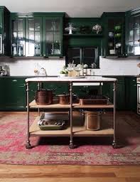 Masculine High Gloss Green Cabinets Faded Persian Rug And Rolling Industrial Kitchen Island Green Kitchen Cabinets Kitchen Cabinet Colors Home Kitchens