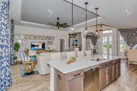 A pendant or chandelier over the dining table also helps to define that space in a vertical sense. Open Floor Plan Showing Family Room Dining Area And Kitchen Stock Photo Picture And Royalty Free Image Image 152880983