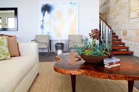 If your coffee table has a lower shelf, like in this living room by park and oak design, you don't have to fill both levels, but if you choose to, try lining up the items on each tier. How To Incorporate Live Edge Wood Decor In Your Home