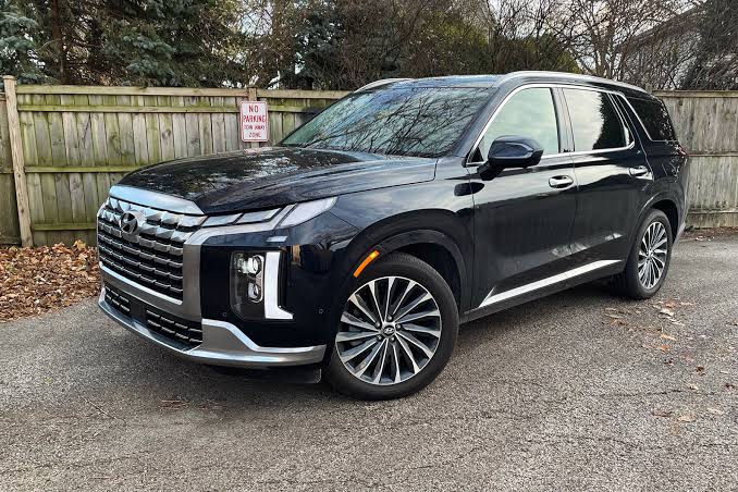 The refreshed front profile highlights the prominent cascading chrome grille architecture., AI generated
