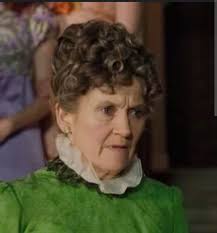 Why does Miss Varley always wear the same green dress?