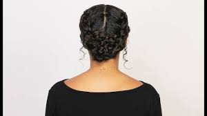 This braided hairstyle screams out festival chic, working fashion wonders alongside your waterproof jacket. A French Braided Bun For Curly And Coarse Hair Types Ouai