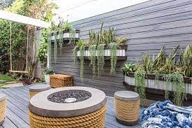 This backyard had a very small concrete. Overflowing Wall Planters Are An Effective Way To Add Interest To An Otherwise Blank Wall