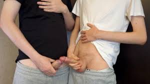 Two guys kiss and jerk off together