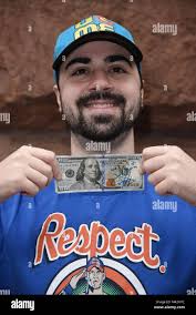 New York, NY, USA. 29th Mar, 2018. John Cena signed $100 for fan James  Gisante to make up for his bad movies at BUILD Series. Cena pulled this  $100 out of his
