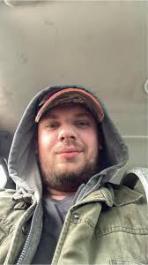 A photo of a purple washroom with accessories like a toilet, sink, and  shower. The toilet has a purple seat and the sink has a purple bowl. The  shower curtain is also