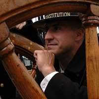 Boatswain s Mate 2nd Class Michael J. Fisk snaps the plastic window panels  into place