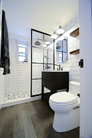 Black and white bathrooms can have their entire look changed just by increasing or decreasing the amount of black you use. E 56th Black White Bathroom Remodel Overview Industrial Badezimmer New York Von Klein Kitchen And Bath Houzz
