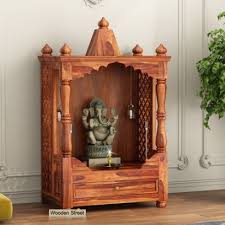 This pooja area created right next to the entertainment unit here retains the monochrome color palette and has silver counter with silver idols and frame. Wooden Home Temple Buy Pooja Mandir For Home Online At 55 Off