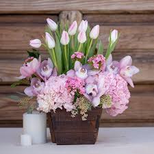 This Beautiful Chinese Wooden Basket Filled With Beautiful Tulips Cimbidium Or Easter Flower Arrangements Spring Flower Arrangements Flower Arrangements Diy
