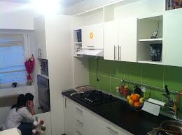 green kitchen backsplash and white cabinets