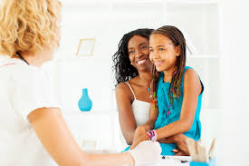 Young patient with parent in a supportive gynecology consultation