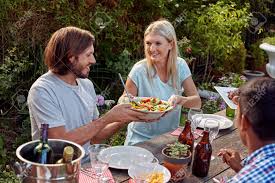 To keep calories lower, this recipe uses cornstarch to thicken the cream instead of cheese. Woman Passing Fresh Healthy Salad At Outdoor Friends Dinner Party Gathering Stock Photo Picture And Royalty Free Image Image 38626327