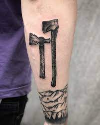 Two Black Axes And Mountains Tattoo On The Right Outer Forearm Tattoos Sleeve Tattoos For Women Tattoos For Women