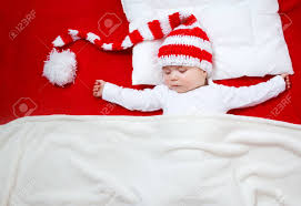 Chunky knit blankets definitely create a decorative impact when showcased in bedroom or living the chunky knit makes the blanket a stylish statement piece that any design enthusiast will love. Sleepy Baby On Red Blanket In Knitted Hat Cute Child Sleeping Stock Photo Picture And Royalty Free Image Image 66130607