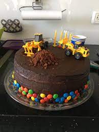 tractor birthday party theme cake layered with dark chocolate ganache and filled with m ms cake themed cakes kids cake