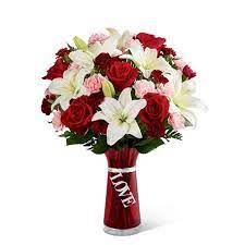 If opting for deep red roses you will want to stick to pink and white toned flowers to complement them. White Lily Red Rose Bouquet At Send Flowers